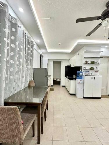a living room with a table and a kitchen at 3BR Fully furnished with Balcony in Davao City