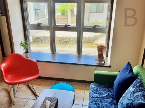 a living room with a couch and a window at コテージマリンロード in Fukai
