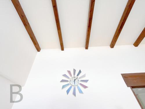 a clock on the ceiling of a room at コテージマリンロード in Fukai