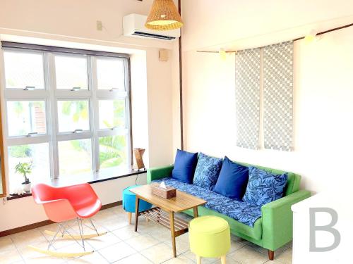 a living room with a couch and a table at コテージマリンロード in Fukai