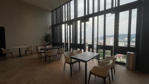 a restaurant with tables and chairs and large windows at Beacon Executive Suites - By IZ in George Town