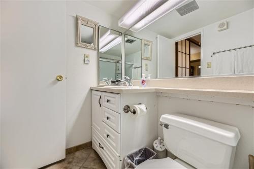 a bathroom with a sink and a toilet and a mirror at Outstanding Location - 1BR Haven near the Strip in Las Vegas