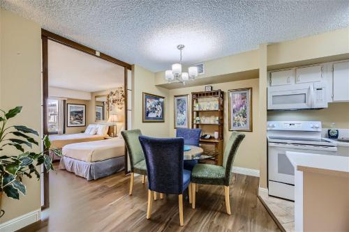 a hotel room with a bed and a table and chairs at Outstanding Location - 1BR Haven near the Strip in Las Vegas