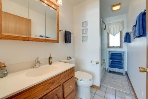 La salle de bains est pourvue d'un lavabo et de toilettes. dans l'établissement Lakeside Michigan Retreat with Boat Dock and Fireplace, à Woodland Beach