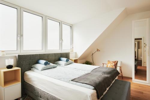 a bedroom with a large bed with blue pillows at New Spacious Ultra-Modern Apartment in Wien Westbahnhof in Vienna