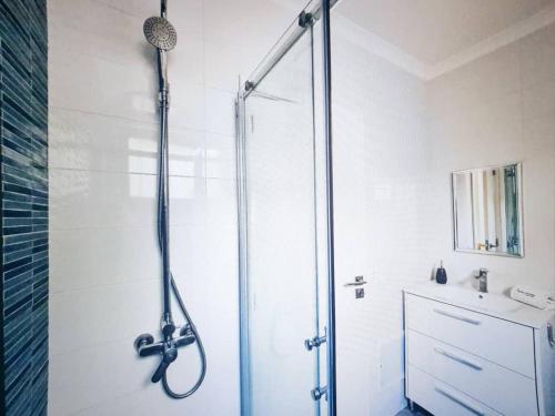 a shower stall in a bathroom with a sink at Casa dos Sinos 2Bedroom Beach Apartment with Terrace in Albufeira