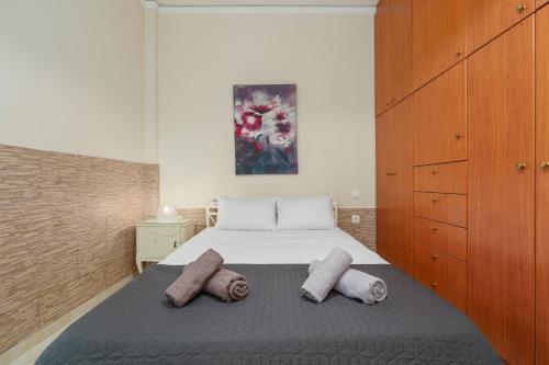 a bedroom with a bed with two pillows on it at Nostos apartment, with a spacious backyard in Artemida