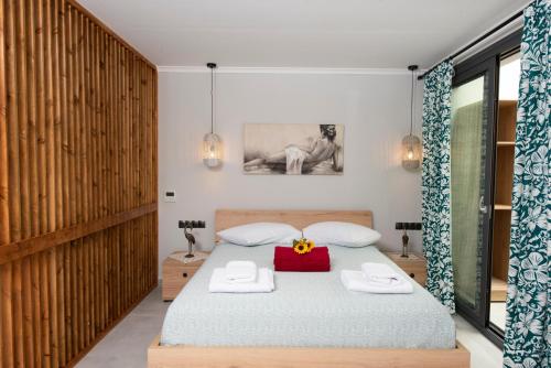a bedroom with a bed with a red box on it at Villa Ilianthi in Kalamitsi