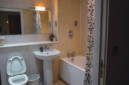 La salle de bains est pourvue d'un lavabo, de toilettes et d'une baignoire. dans l'établissement Modern City Nest With Parking, à Birmingham