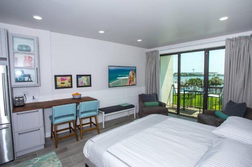 a bedroom with a bed and a desk with a desk at Pirates Bay A308 in Fort Walton Beach