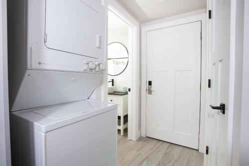 a kitchen with a white refrigerator and a white door at Pirates Bay A308 in Fort Walton Beach