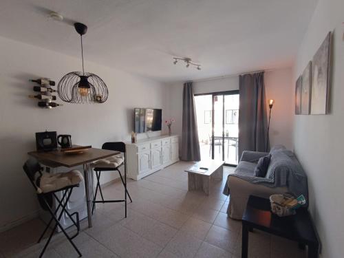 a living room with a couch and a table at Apartamento LIFE Complex Amaya Fuerteventura in Costa de Antigua