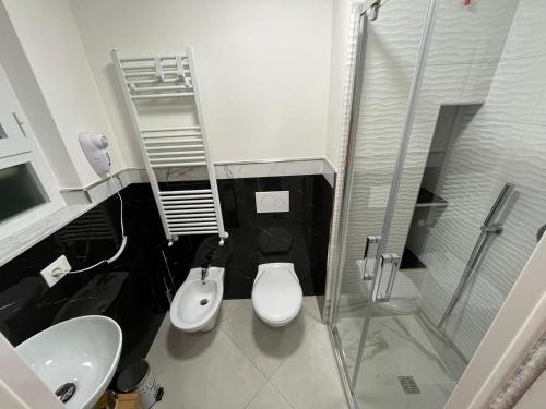 a bathroom with a shower and a toilet and a sink at Cherry rooms in La Spezia