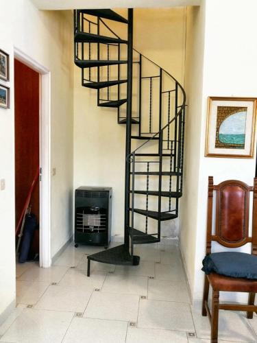 a spiral staircase in a room with a living room at Charming Villa in Monreale with Private Pool in Pioppo