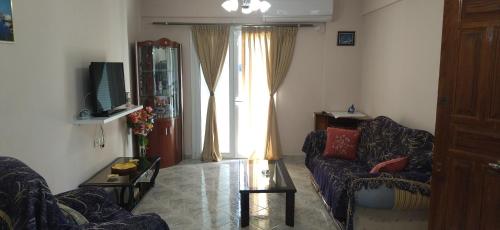a living room with a couch and a window at Mihalis Vrion Apartment in Vrion