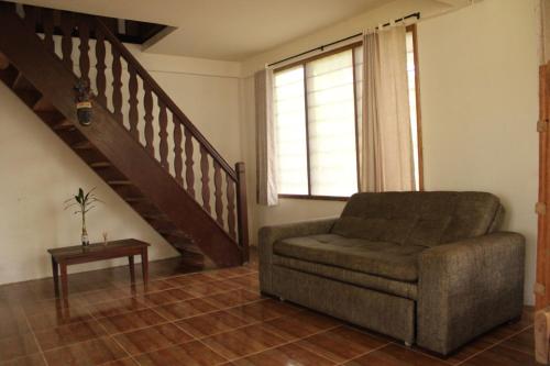a living room with a chair and a staircase at Hotel Karupa Amazonas in Leticia