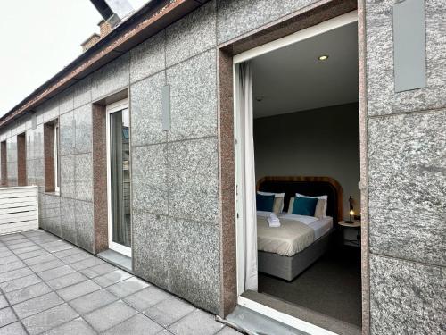 a bedroom with a bed on a balcony at Hotel George Vienna in Vienna