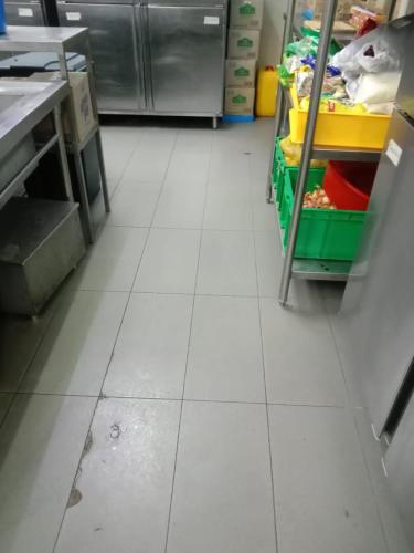 a kitchen with a white tiled floor in a store at Peace Ghor in Kuala Lumpur