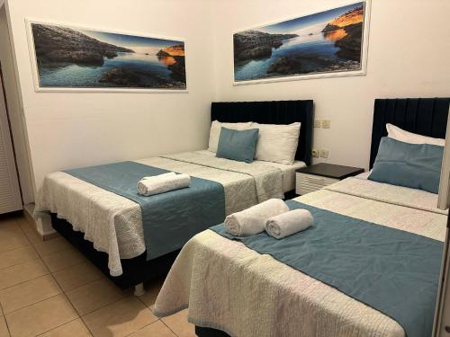 a hotel room with two beds with towels on them at Devran Pansiyon in Bodrum City