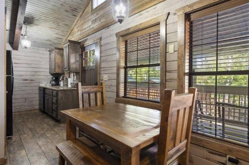 a dining room with a wooden table and a kitchen at Lake Front Cabin on Indian Point in Branson