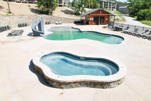 a swimming pool with a slide and a water park at Lake Front Cabin on Indian Point in Branson