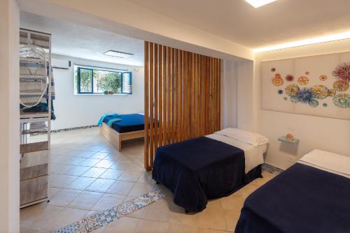 a hotel room with two beds and a window at Dimore di mare - Beachfront Apartments in Santa Flavia