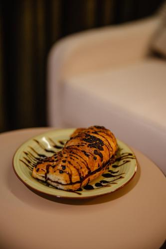 a banana sitting on a plate on a table at Oro Inn Hotel in Shkodër