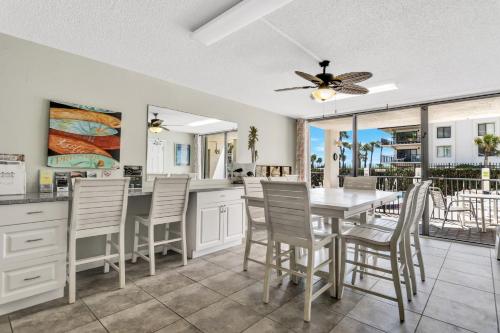 a kitchen and dining room with a table and chairs at Cape Winds Resort in Cape Canaveral