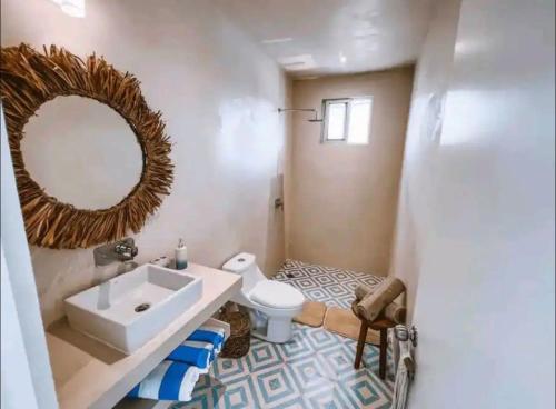 a bathroom with a sink and a toilet and a mirror at Rosa Azul Tulum in Tulum