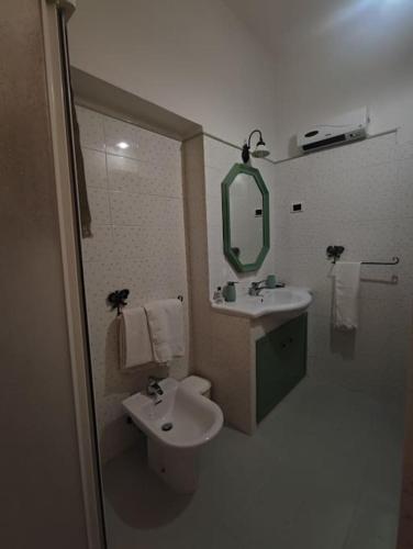 a bathroom with a sink and a toilet and a mirror at Pink house in Fara in Sabina