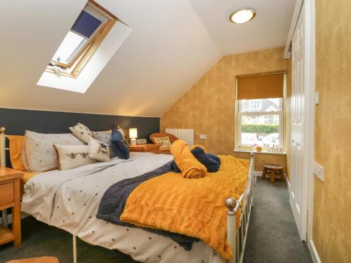 a bedroom with two beds and a window at The Forest Coach House in Cinderford