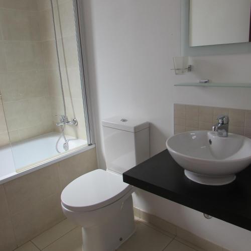 a bathroom with a white toilet and a sink at Tortuga Beach Resort 3 Bed Villa with pool in Santa Maria