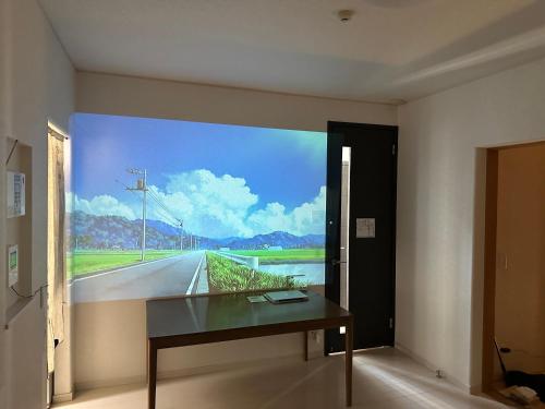 a room with a painting of a road on the wall at 清水公園四个房间 in Noda