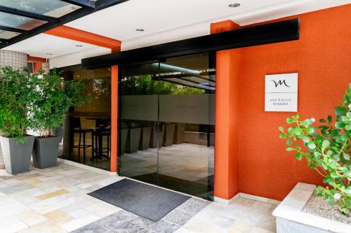 an entrance to a building with an orange wall at Mercure Sao Paulo Berrini in Sao Paulo
