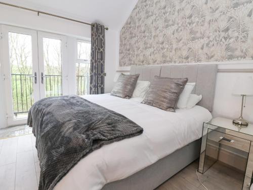 a bedroom with a bed with a blanket on it at 4 Lock View in Skipton