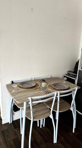 ein Holztisch mit drei Platten darüber in der Unterkunft Appartement confort in Vanves