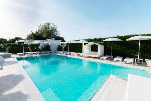 a large swimming pool with chairs and umbrellas at Il Leone Di Mare in Procida