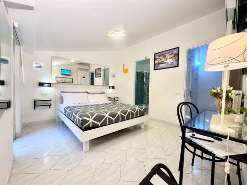 a bedroom with a bed and a table and a desk at Il BorGhetto Guest House in Civitavecchia
