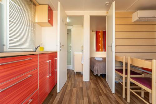 a kitchen with wooden cabinets and a dining room at Quinta Solar da Portela in Almodôvar