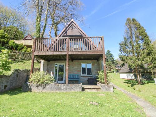 a house with a large deck on top of it at Valley Lodge 44 in Callington