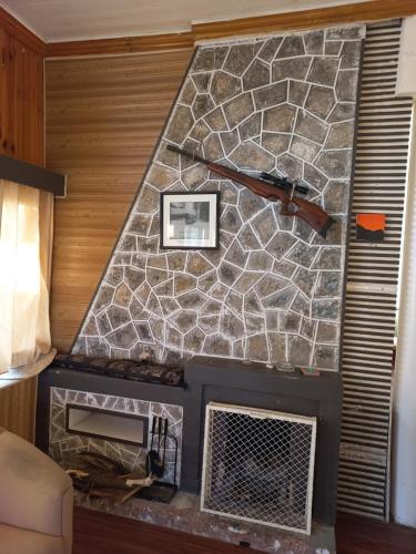 a room with a stone wall with a fireplace at Batrasi Dak Bungalow in Uttar Shisha
