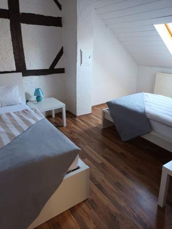 a bedroom with two beds and a wooden floor at Ferienhaus Valler in Vallendar