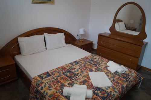 a hotel room with a bed with a mirror and a mirror at Tea's sea apartments in Siviri