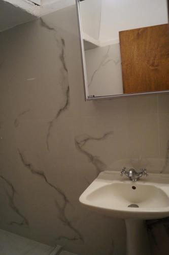 a bathroom with a sink and a mirror at Tea's sea apartments in Siviri