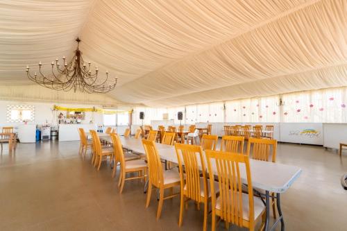 a dining room with a long table and chairs at Quinta Solar da Portela in Almodôvar