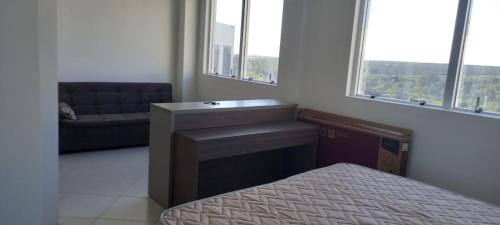 - une chambre avec un lit, un lavabo et un canapé dans l'établissement Apartamento nas dependencias do Recinto de Rodeio em Barretos, à Barretos
