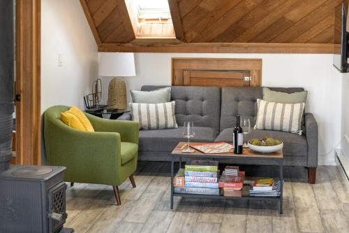 a living room with a gray couch and two green chairs at Sunset View in Portsmouth