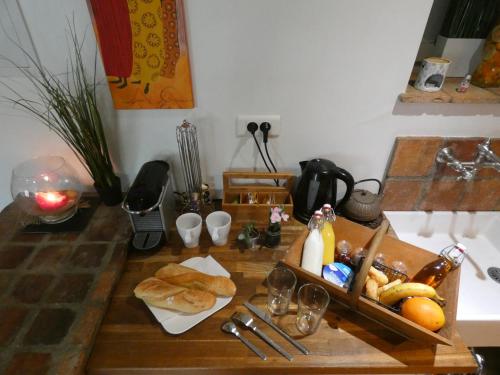 a table with a tray of food and bread on it at La Closerie DAUVILLIERS in Roinville