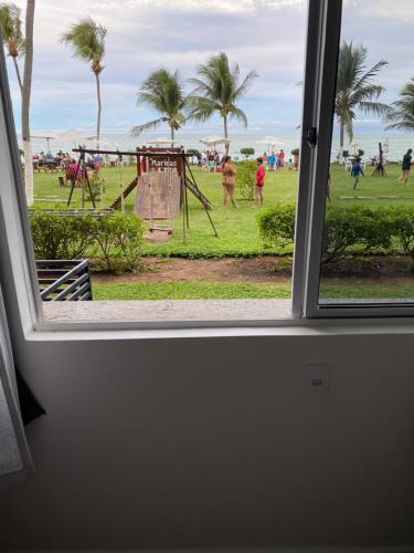 a window view of a park with a playground at Apart Hotel Marinas Tamandaré in Recife