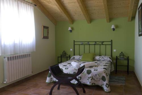 a bedroom with a bed and a chair at El Quinto Pino in Pino